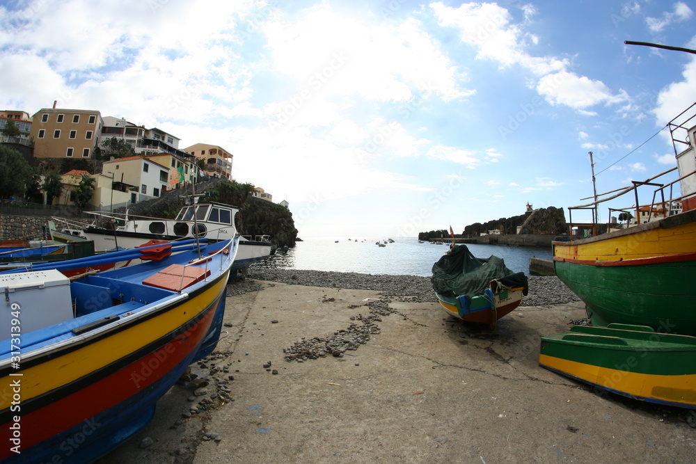 some fishing boats in the harbor in camera de lobos at Madeira island
