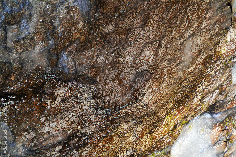 Brown textured wall, texture on a wall inside a cave. Brown textured wall, texture on a wall inside a cave.