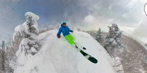 SELFIE: Young freeride skier carves down an ungroomed slope in Park City, Utah. photo