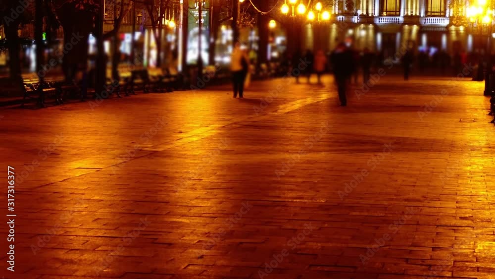 The movement of people along the boulevard night avenue. Time lapse. The movement of people along the boulevard night avenue. Time lapse.