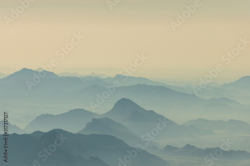 Scenic mountains range background in morning haze