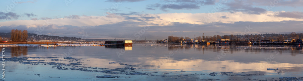 Beautiful Panoramic View of Fraser River in the City during a cold and icy winter sunset. Taken in New Westminster, Vancouver, British Columbia, Canada.