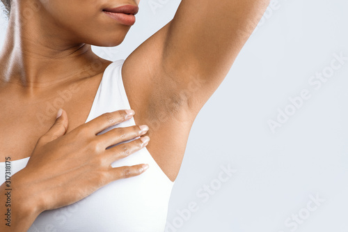 Cropped of black girl smelling her armpit