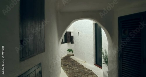 Binibeca old fishing village in Minorca, Balearic Islands, Spain. Walking for very narrow streets of the traditional Mediterranean architecture. Wide angle view with personal perspective camera move. 