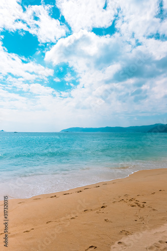 Sea beach scenery with beautiful water and clouds. vertical orientation © nikkimeel