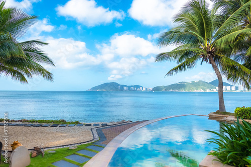 The turquoise swimming pool by the sea. Beautiful landscape  blue sea and sky with white clouds