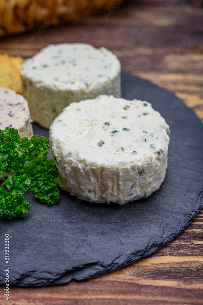 Spread cream cheese with herbs, garlic, chives and spices close up Spread cream cheese with herbs, garlic, chives and spices close up