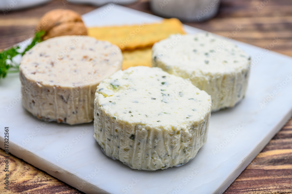 Spread cream cheese with herbs, garlic, chives and spices close up