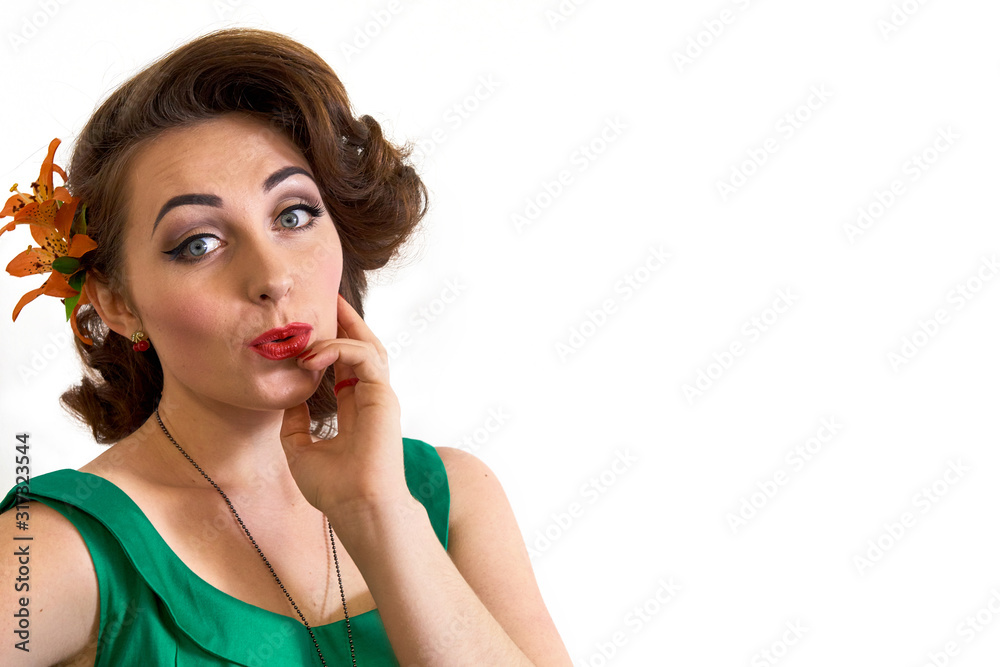 Beautiful happy smiling thinking model woman in green. Retro style. The girl has red lips. Hairstyle with a flower. Close-up portrait isolated on a white background. Fashion and beauty. Beautiful happy smiling thinking model woman in green. Retro style. The girl has red lips. Hairstyle with a flower. Close-up portrait isolated on a white background. Fashion and beauty.
