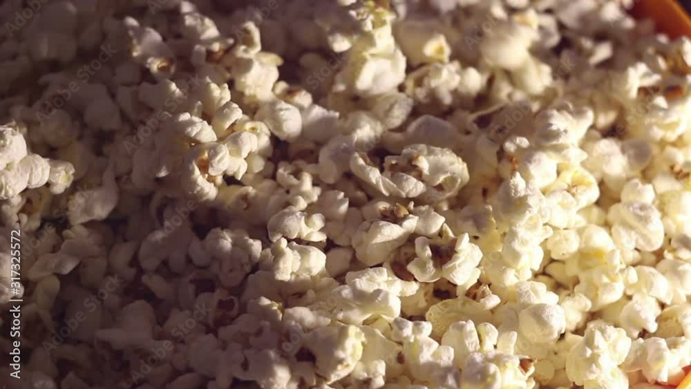 Fresh crispy popcorn drops in a bucket. Fresh hot popcorn drops in a bowl.Cinema pop corn background. Fresh crispy popcorn drops in a bucket. Fresh hot popcorn drops in a bowl.Cinema pop corn background.