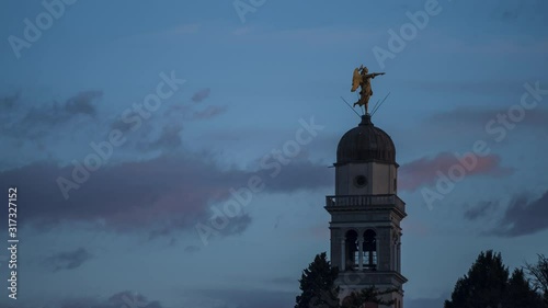Sunset Timelapse (blue hour) of the bell tower with angel statue at Castle of Udine, zoom out