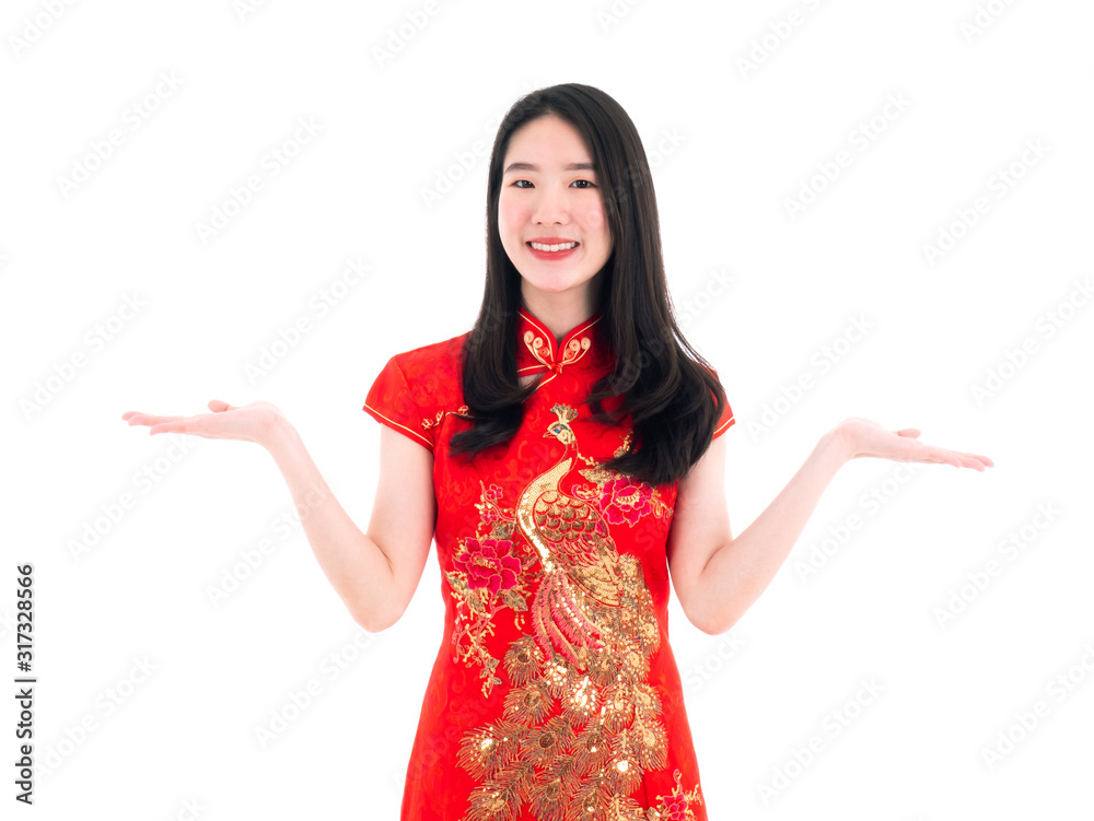 Asian Chinese young girl smile and happy wear traditional red qipao or cheongsam dress with golden peacock detailed and show balance hand gesture on isolated white background for New Year festival Asian Chinese young girl smile and happy wear traditional red qipao or cheongsam dress with golden peacock detailed and show balance hand gesture on isolated white background for New Year festival