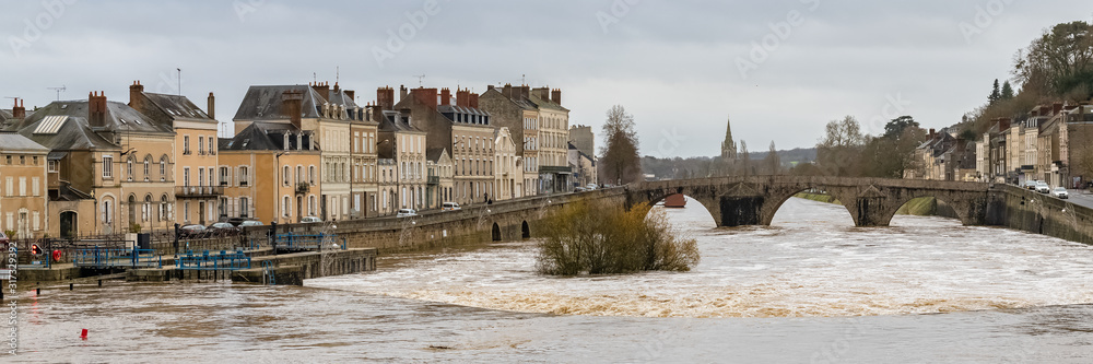 Laval, beautiful french city, panorama of the river and typical houses in the ancient center, downtown under the floods, the river in flood