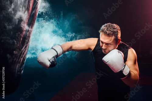 attractive man training boxing in the punching bag - sport, boxi photo