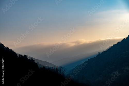 Misty clouds at sunrise in the mountains