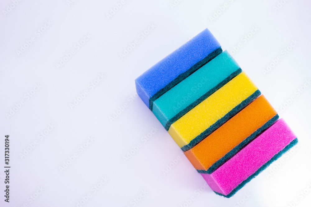 Sponges for washing dishes, on a white background, isolated. Colorful multi-colored as rainbow sponges lay one each other. Copy space Sponges for washing dishes, on a white background, isolated. Colorful multi-colored as rainbow sponges lay one each other. Copy space