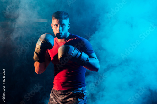 Portrait muscular and handsome boxer in fighting pose with profe