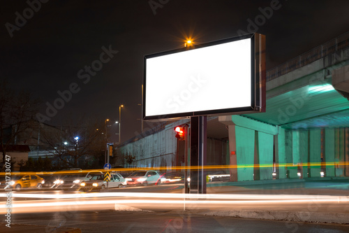 Blank billboard in night traffic