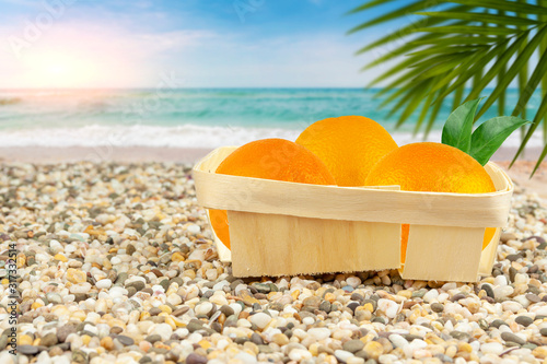 Oranges in a basket by the warm sea.