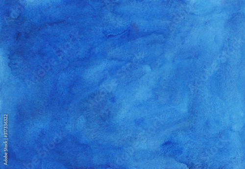 Watercolor sky blue background texture hand painted. Cerulean stains on paper.