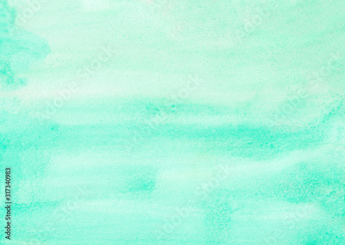 Watercolor aquamarine color background texture hand painted. Light turquoise blue stains on paper.