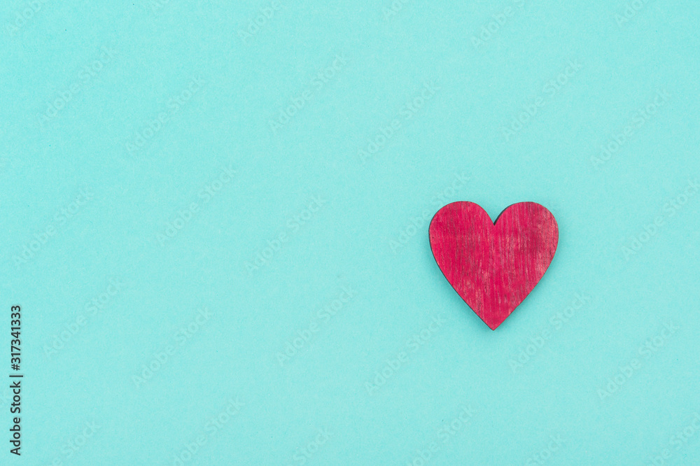 Wooden heart over pastel green background. Valentine's Day Background