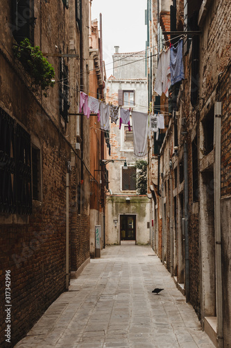 Lonely street of the city of Venice  Italy. Clothes hanging