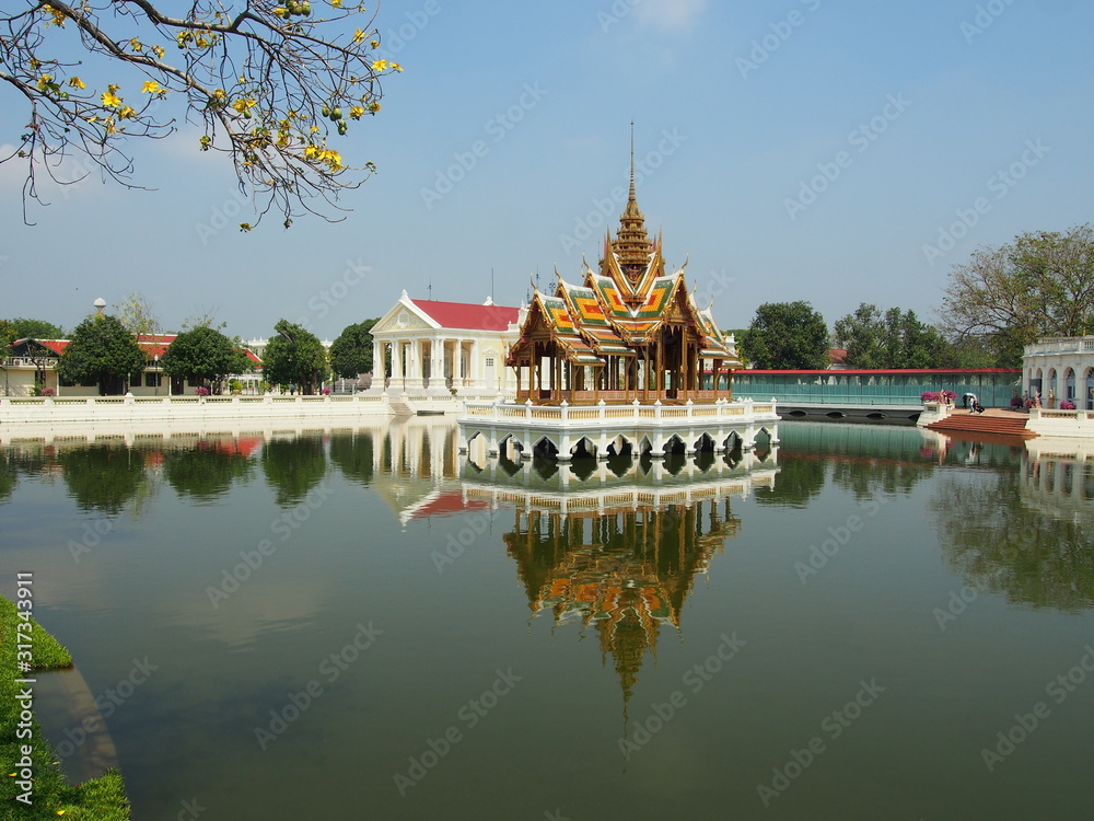 Buddhist gazebo is in the centre of the lake with reflection in water