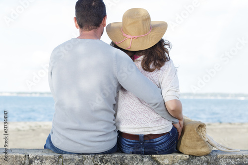 couple sitting looking to the sea © auremar