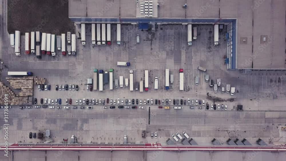 Cargo logistic terminal with a lot of trucks. Aerial drone top down 4k video. Cargo logistic terminal with a lot of trucks. Aerial drone top down 4k video.