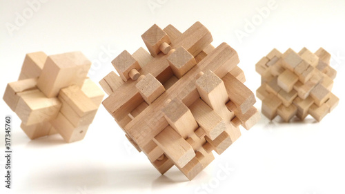 Burr Puzzles   Interlocking Puzzles   Close up of Three-Dimensional Wooden Puzzles on a White Background