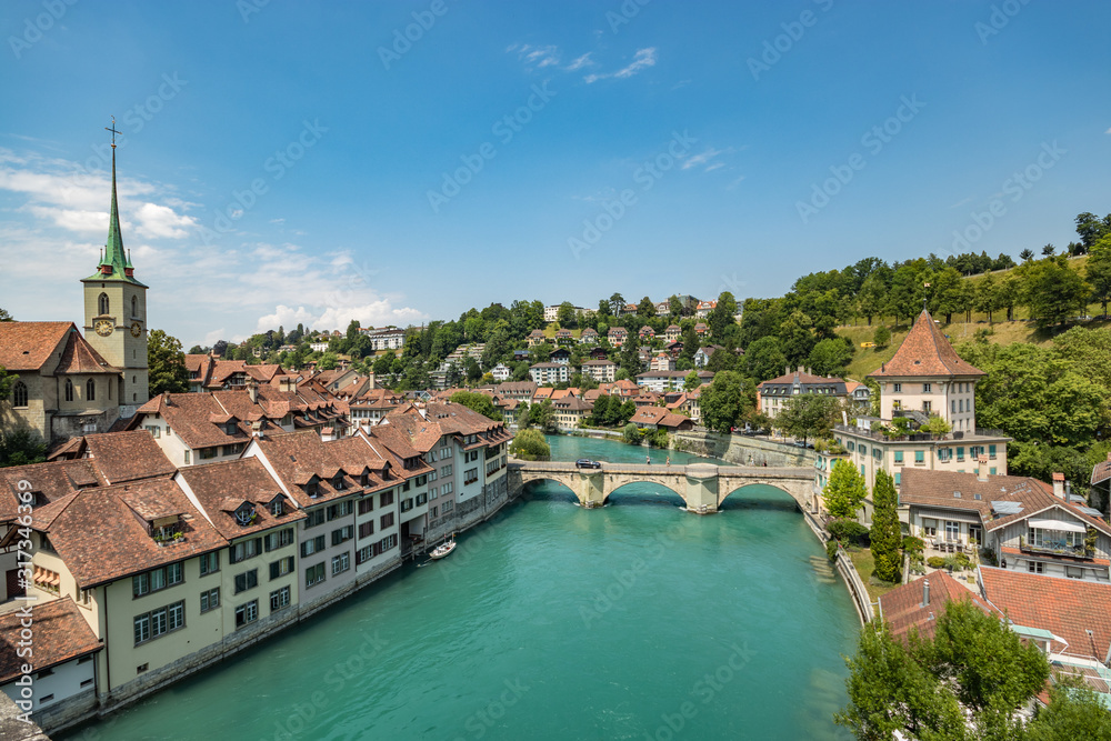 Naklejka premium Bern, Switzerland - July 26, 2019: Panoramic view from one of the bridges. . Aare river at sunny summer day
