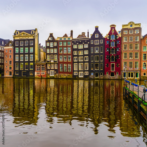 Old dutch medieval houses in Amsterdamon, view through the canal