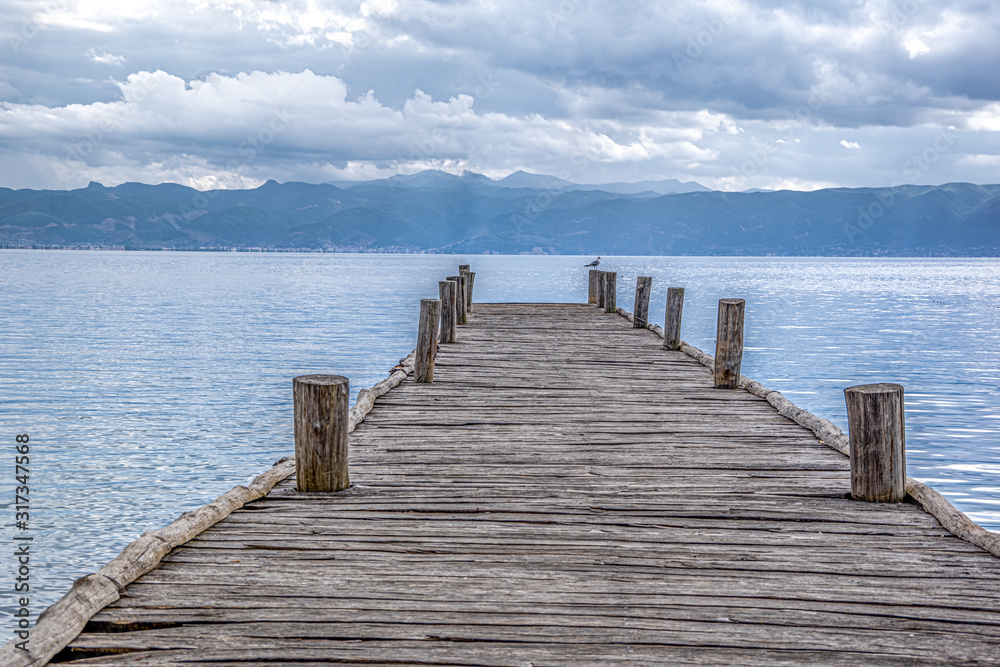 Close up of one old wooden pier. Ohrid Lake, Spring,  North Macedonia.Concept of traditional architecture.