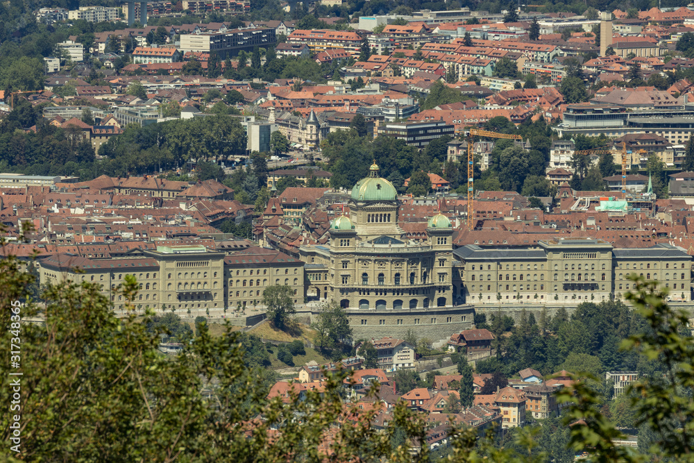 Bern, Switzerland - July 30, 2019: Panoramic view at sunny summer day fro the top of Gurten Mountain Park. Telephoto lens shot