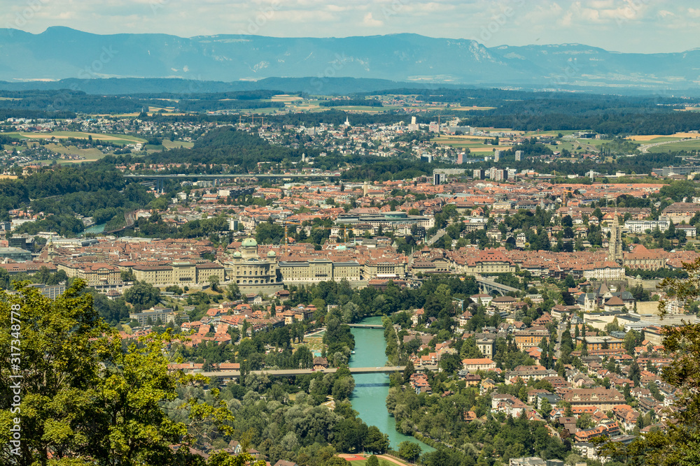 Bern, Switzerland - July 30, 2019: Panoramic view at sunny summer day fro the top of Gurten Mountain Park. Telephoto lens shot