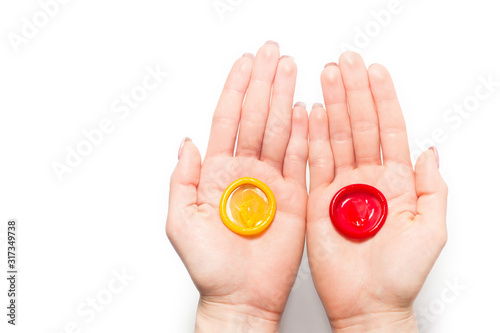 color condom in female hand isolated on a white background