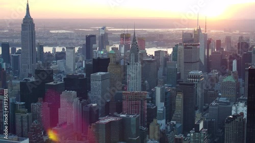 Aerial view of Manhattan skyline and cityscape. Iconic skyscrapers. Sunset in New York City, United States. Shot from a helicopter.