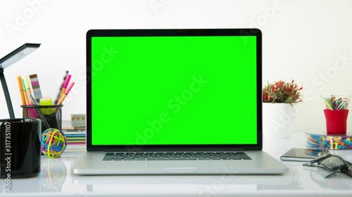 Laptop with colorful office elements. Dolly in. Chroma Key. Perfect to put your own images or videos. Track with perspective corner pin.   