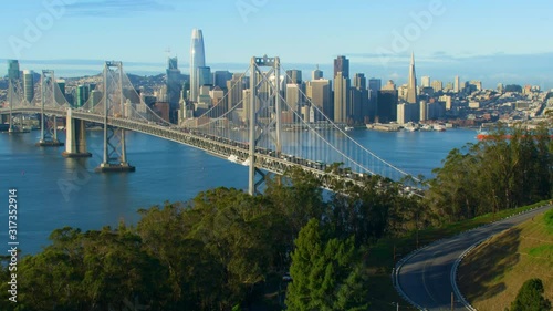Aerial view of the San Francisco Oakland Bay Bridge. California, US. With traffic. Financial District skyline with its well known skyscrapers. Shot on Red weapon 8K.