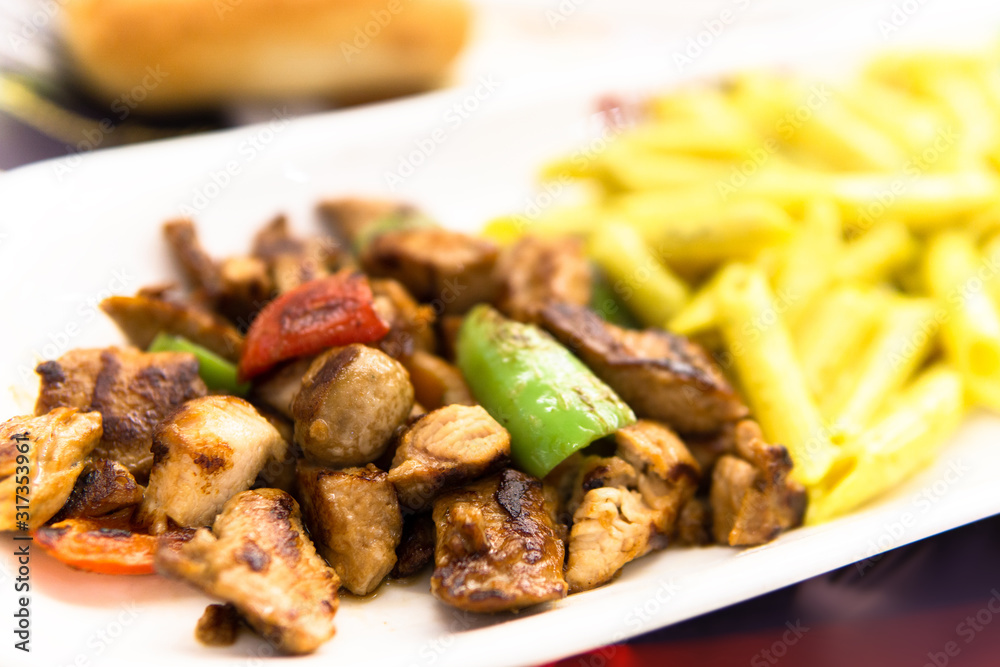 chicken saute meal with green pepper and tomato in white plate chicken saute meal with green pepper and tomato in white plate