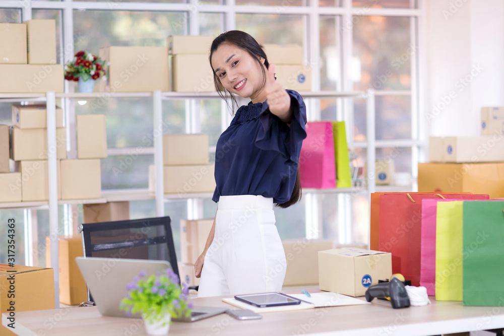 Asian young women happy after new order from customer. Smile and looking at laptop. Online shopping SME entrepreneur or freelance working concept. Asian young women happy after new order from customer. Smile and looking at laptop. Online shopping SME entrepreneur or freelance working concept.