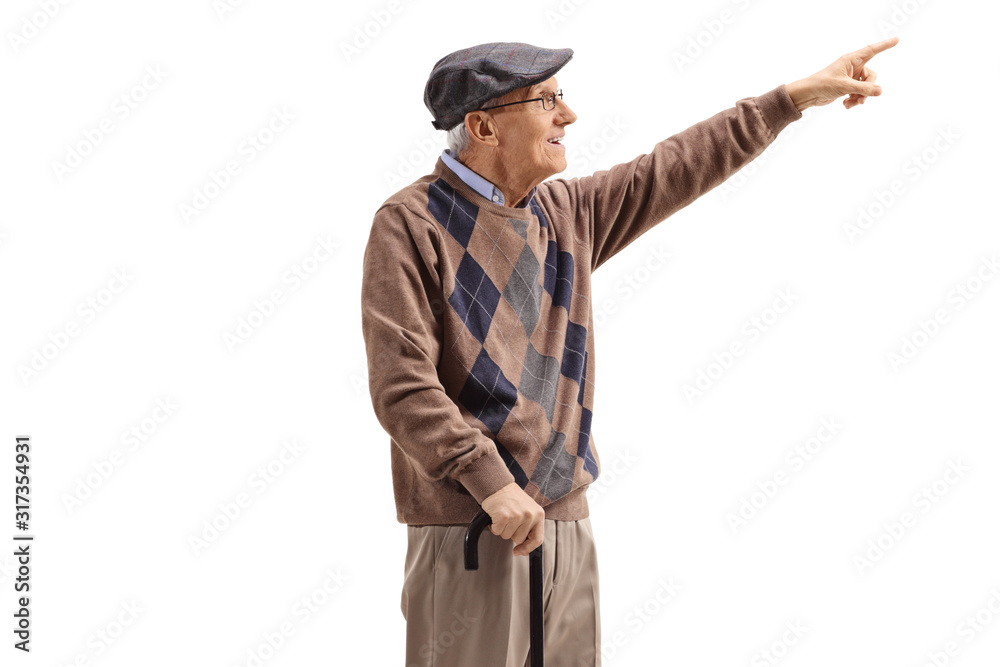 Senior man standing with a cane and pointing up in the distance Senior man standing with a cane and pointing up in the distance