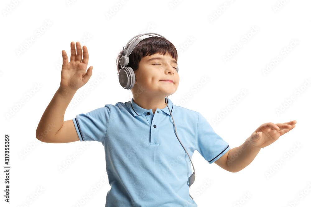 Cute little boy dancing with closed eyes and listening to music on headphones Cute little boy dancing with closed eyes and listening to music on headphones