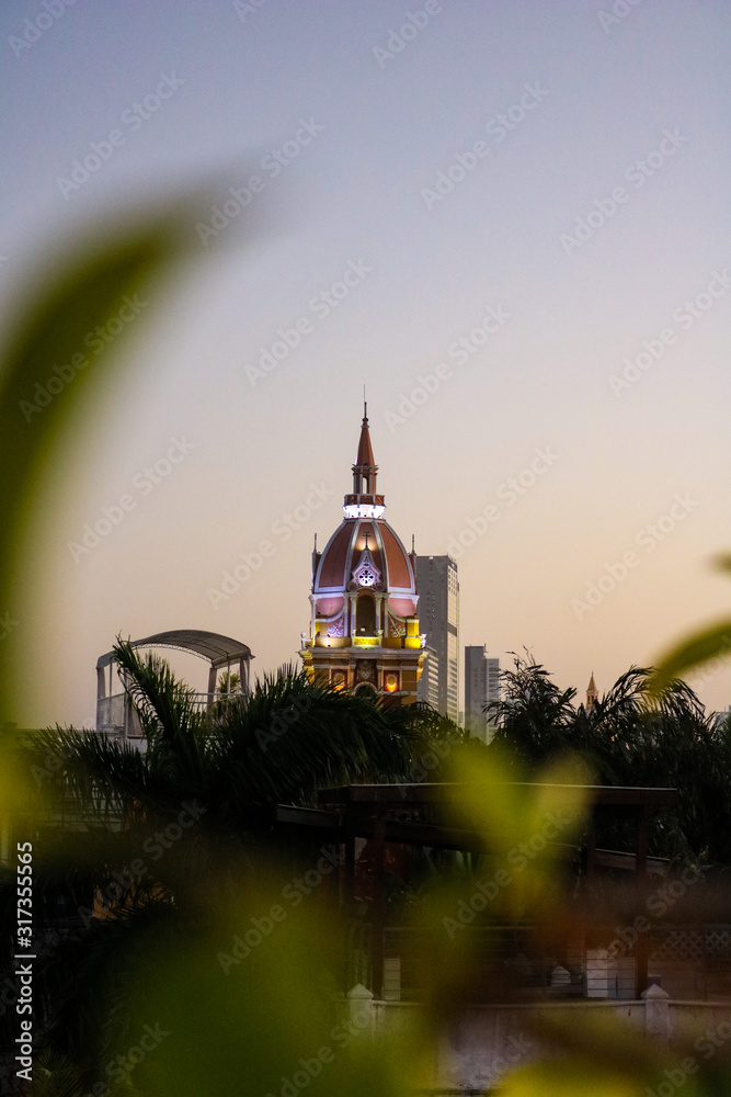 View of the illuminated Church of St Peter Claver in Cartagena, Colombia during sunset.