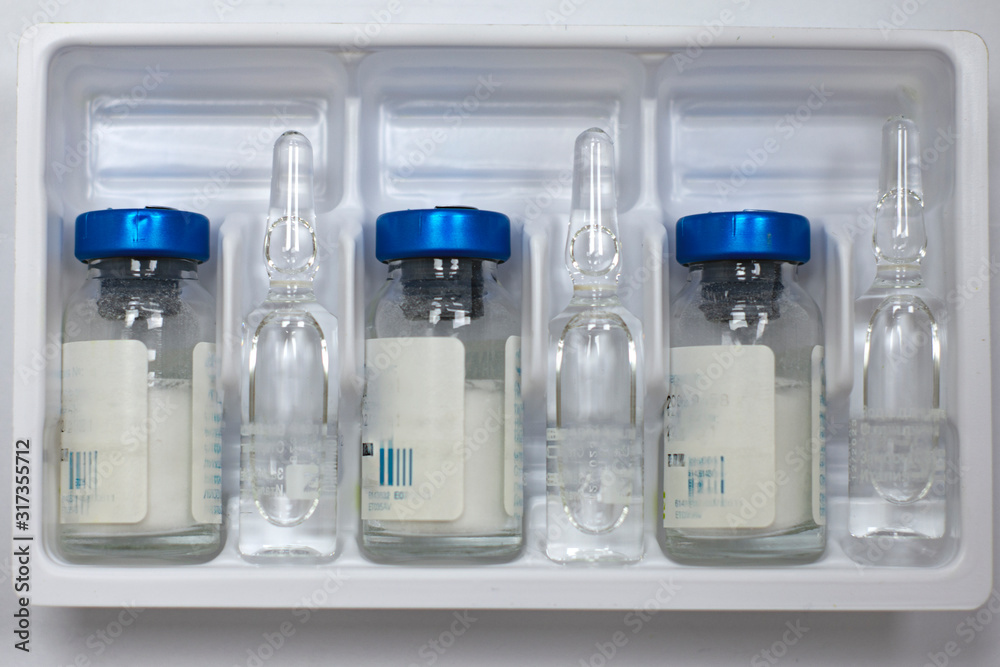 Antibiotics in glass jars with vials on a white background Antibiotics in glass jars with vials on a white background