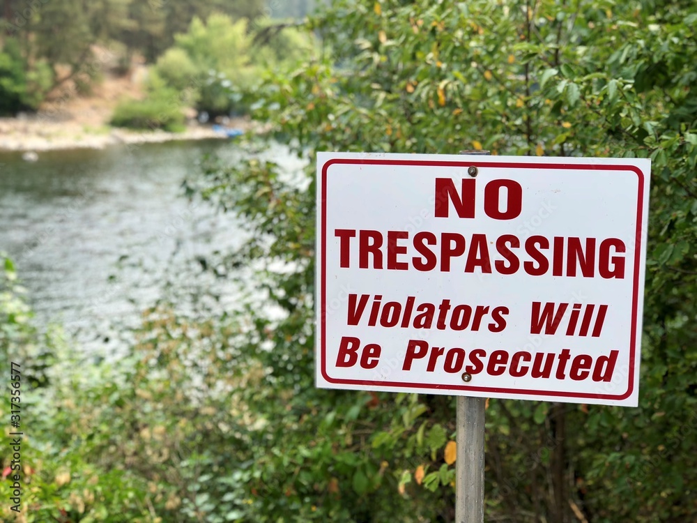 No trespassing sign - river visible in background