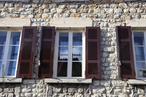 Fototapeta Naklejka Na Ścianę i Meble -  Immeuble typique avec façade en pierre dans le village de Ambronay - Département de l'Ain - Région Rhône Alpes - France - Vue extérieure