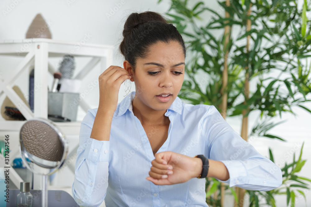 woman running late while getting ready for work woman running late while getting ready for work