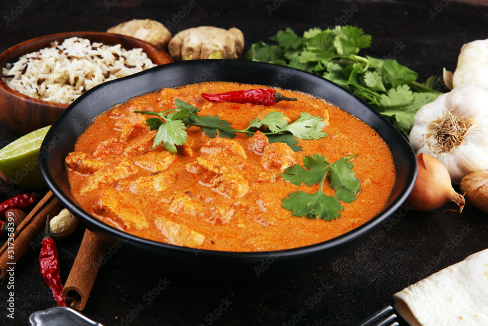 Chicken tikka masala spicy curry meat food in pot with rice and naan bread. indian food